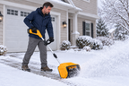 Yellow FLEIGIN cordless snow shovel shown in a snowy driveway